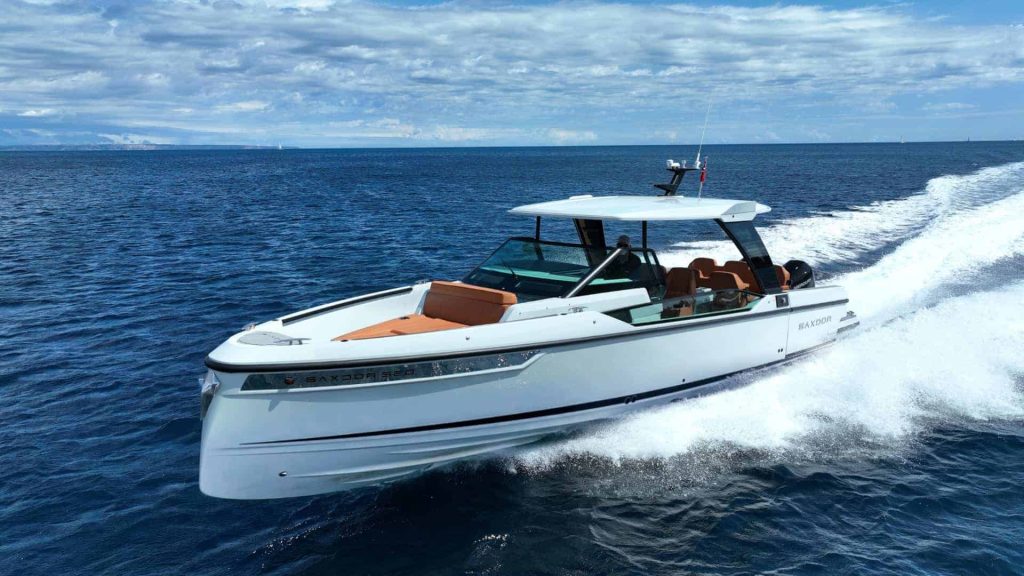 Luxurious Paralos, a Saxdor 320 GTO yacht, glides over the calm blue waters of Halkidiki, showcasing the perfect blend of speed and elegance for a private yacht charter.