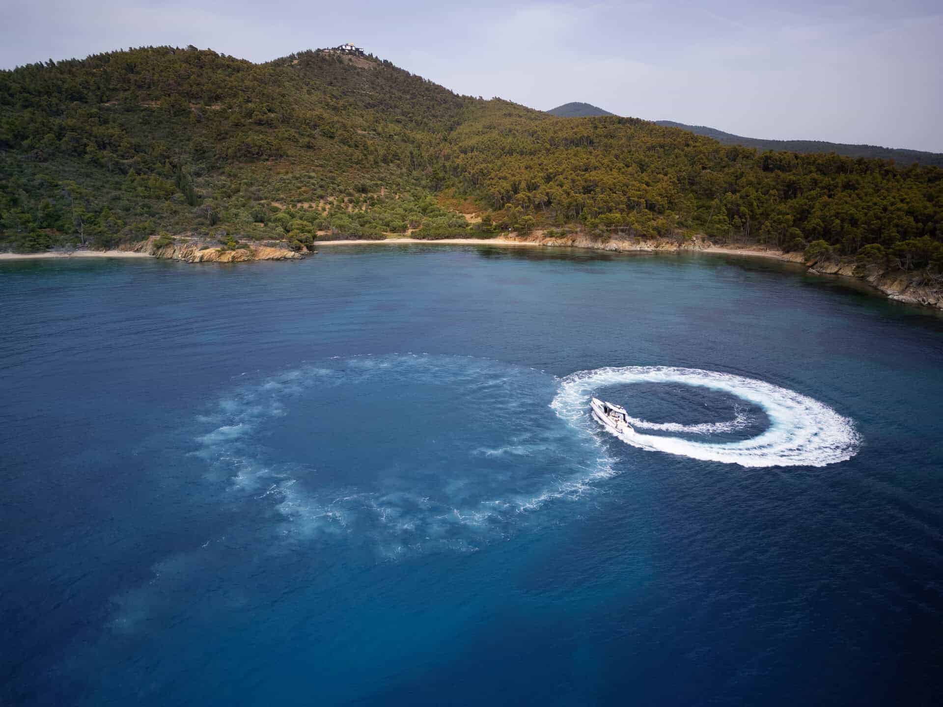 Aerial View of Paralos Performing a Turn in a Serene Bay
