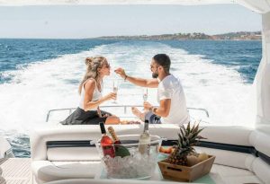 A couple enjoys a romantic meal with champagne on the aft deck of a yacht